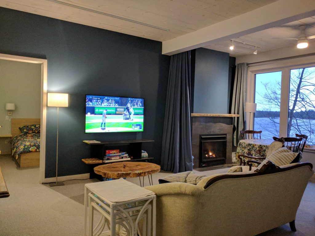 Family room with fireplace, TV, games table, and king bed pulllout