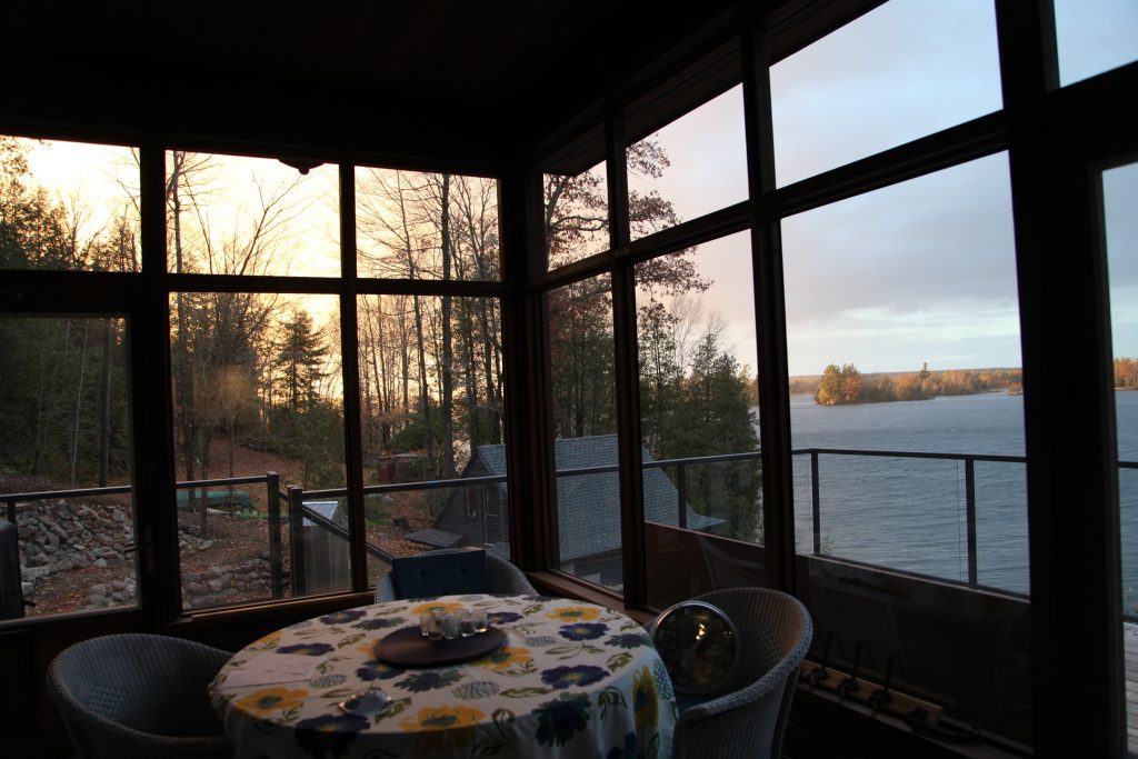 Screened porch looking out to sunset view 